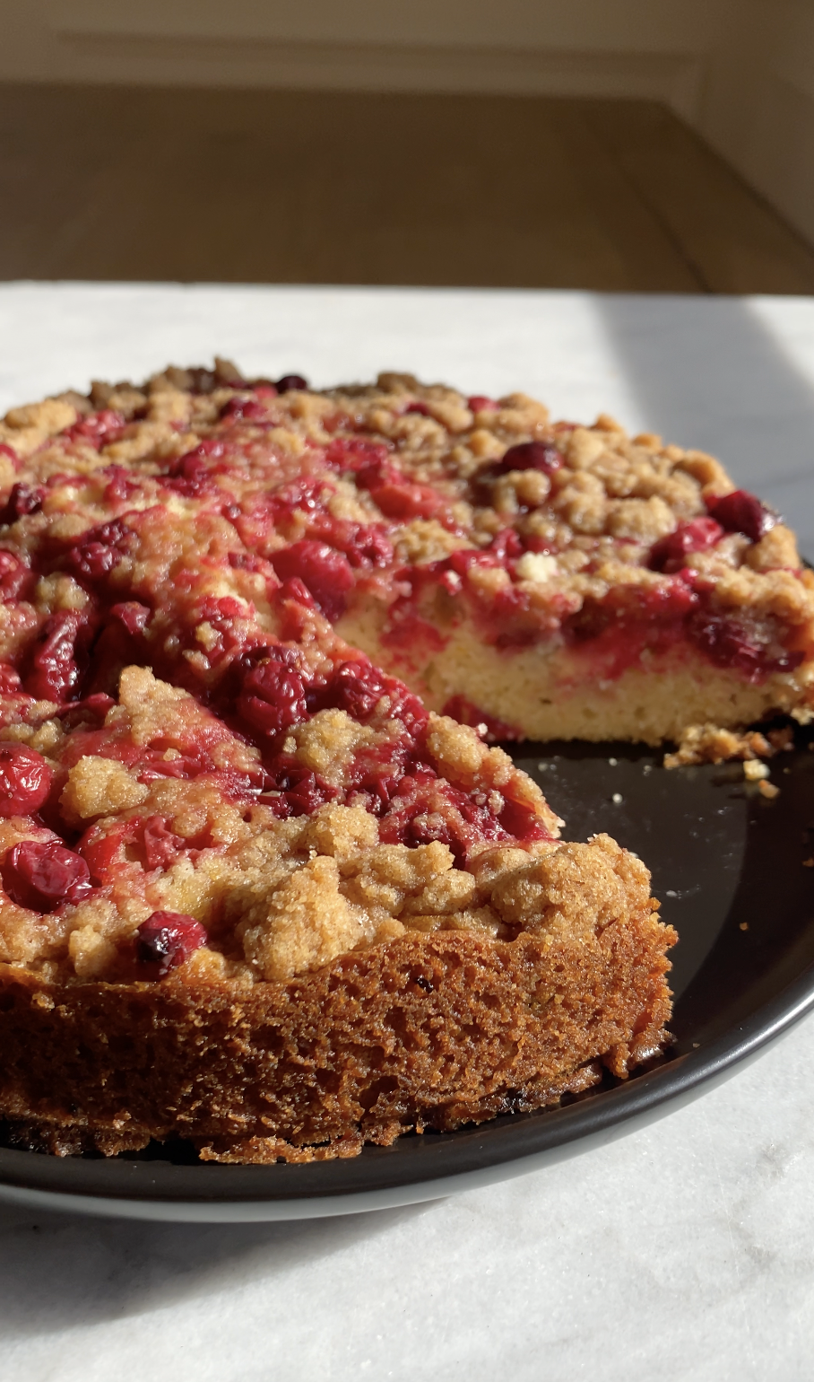 cranberry coffee cake on a black plate