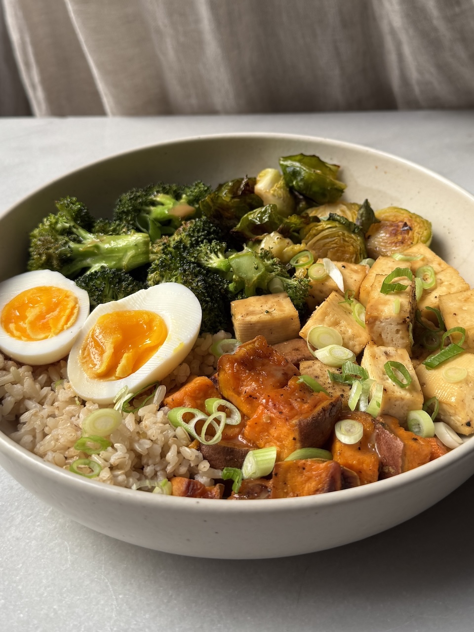 bowl with tofu, veggies, soft-boiled egg, and brown rice