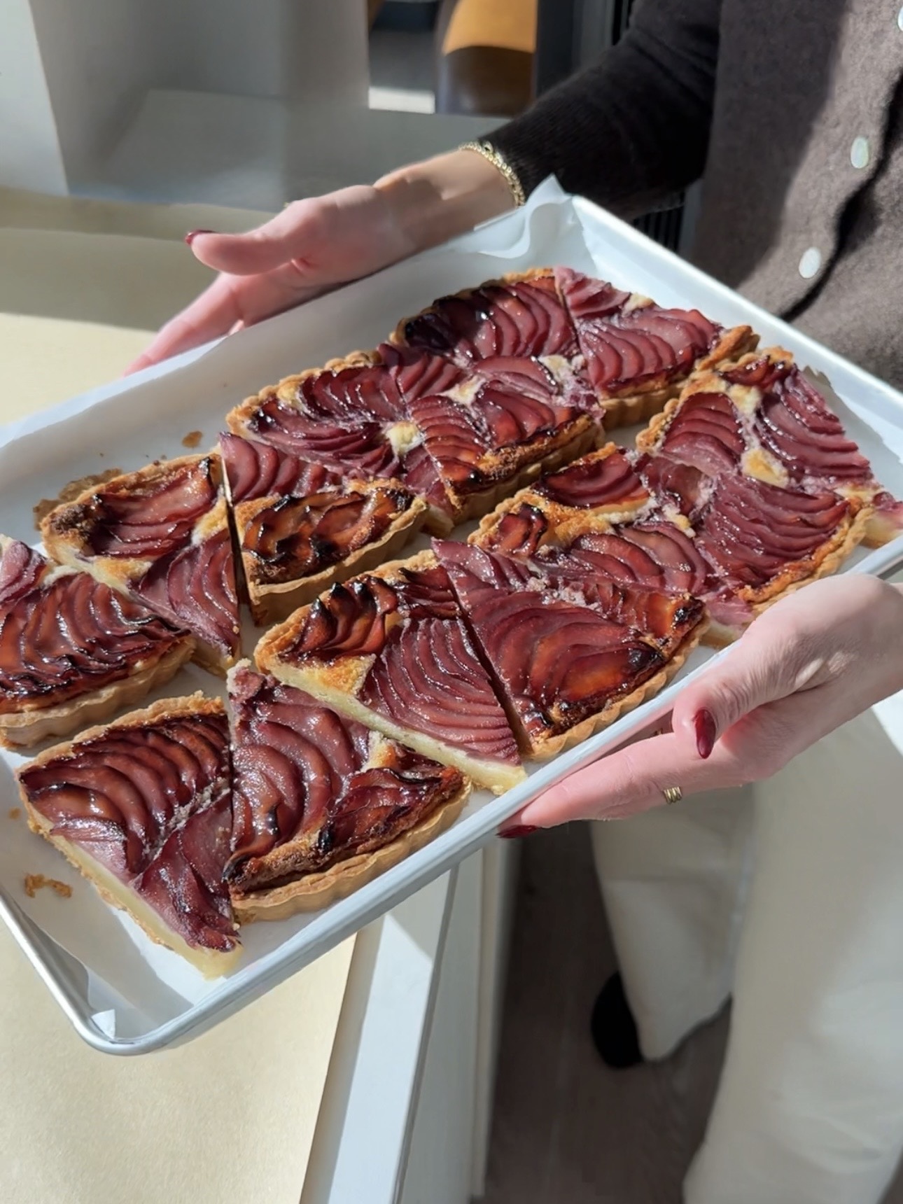 slices of almond pear tart on a sheet pan